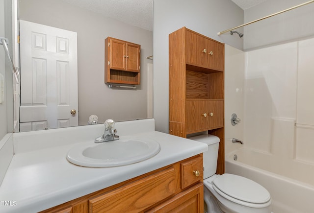 full bathroom featuring shower / bathing tub combination, vanity, toilet, and a textured ceiling