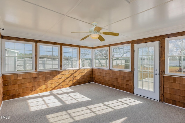 unfurnished sunroom with ceiling fan