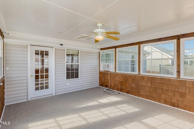 unfurnished sunroom featuring ceiling fan