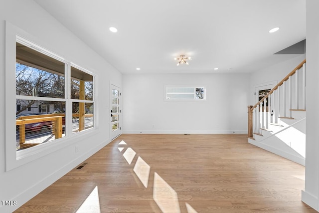 unfurnished living room with a wealth of natural light and light hardwood / wood-style floors