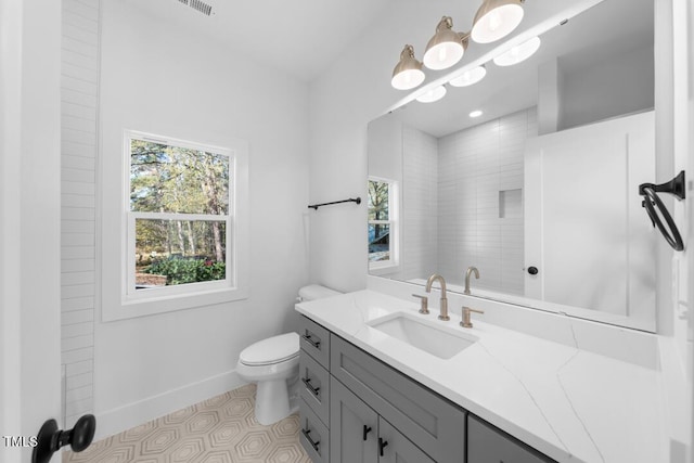 bathroom with tile patterned flooring, vanity, and toilet