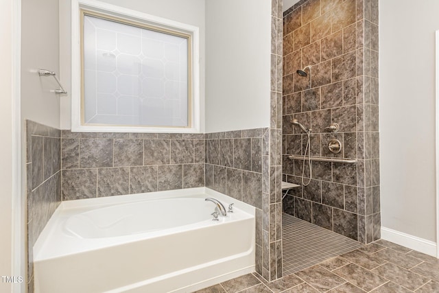 bathroom with shower with separate bathtub and tile patterned floors