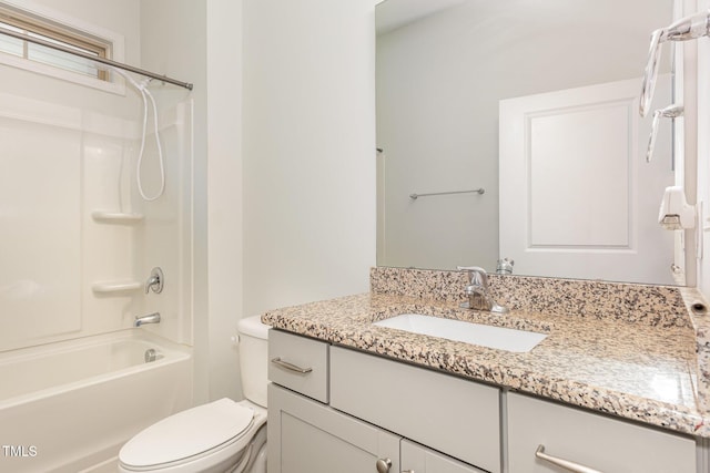 full bathroom with vanity, toilet, and washtub / shower combination