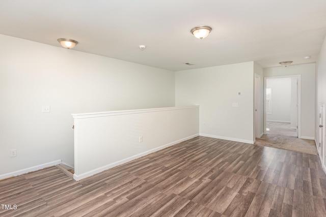 unfurnished room featuring dark hardwood / wood-style flooring