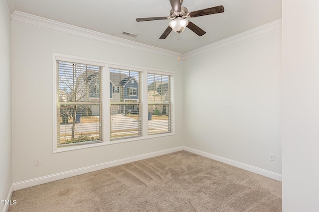 spare room featuring light carpet, crown molding, and ceiling fan