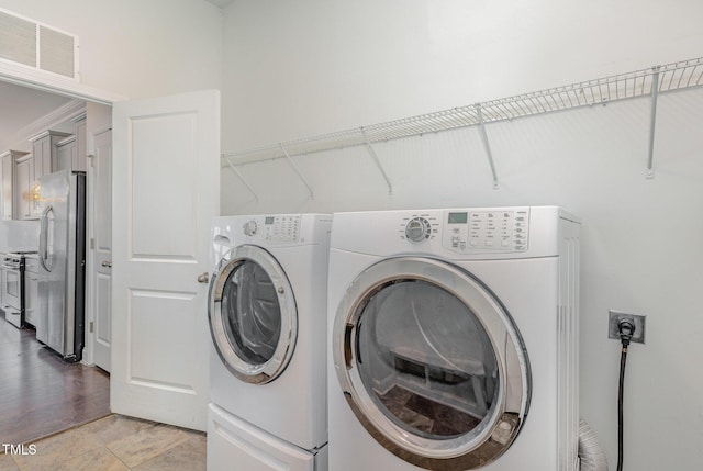 laundry area featuring washer and dryer and light wood-type flooring