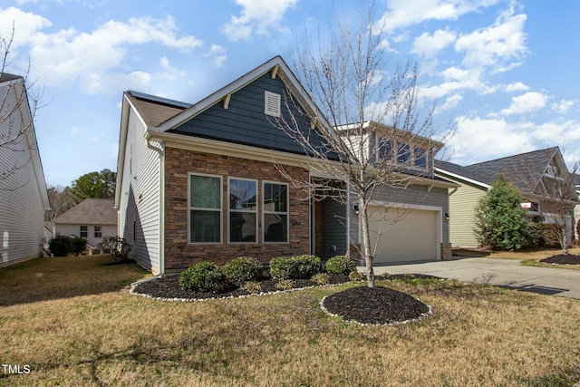 view of front of property with stone siding, driveway, and a front yard