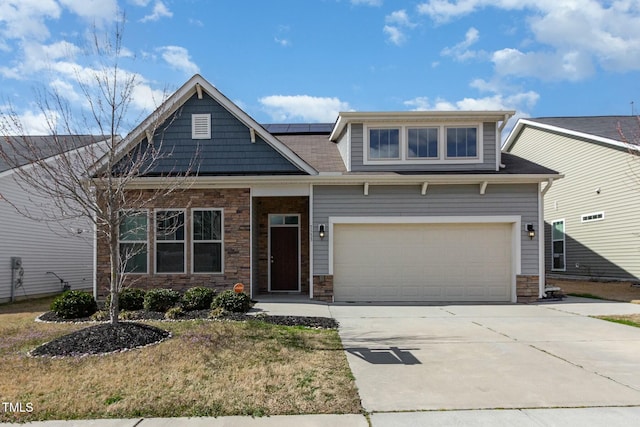 craftsman-style house featuring stone siding, solar panels, and concrete driveway