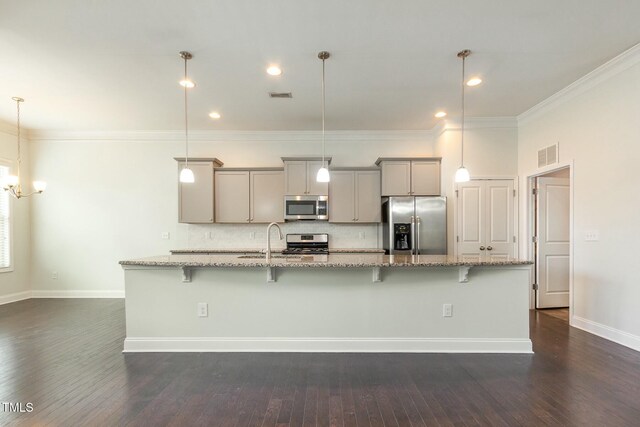 kitchen featuring gray cabinetry, visible vents, a large island with sink, and stainless steel appliances