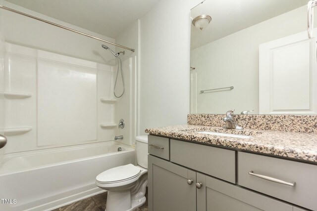 full bath featuring toilet, vanity, and shower / bathing tub combination