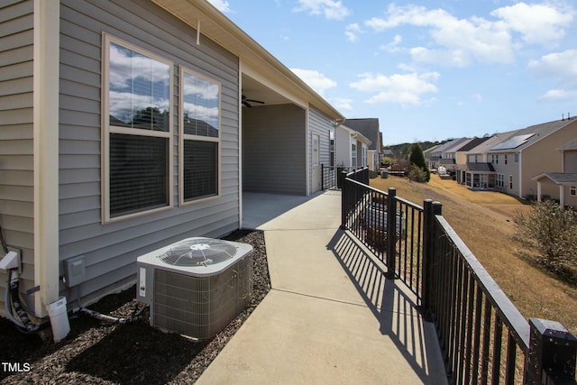 balcony featuring a residential view, central AC, and a ceiling fan