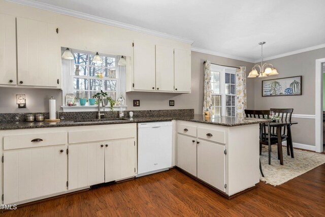 kitchen featuring sink, a notable chandelier, kitchen peninsula, white dishwasher, and white cabinets