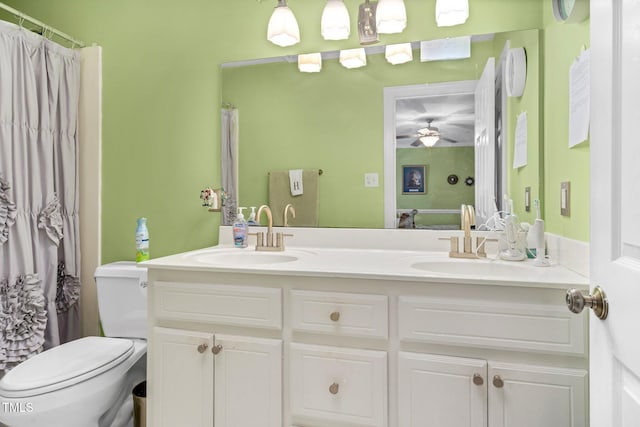 bathroom featuring ceiling fan, toilet, walk in shower, and vanity