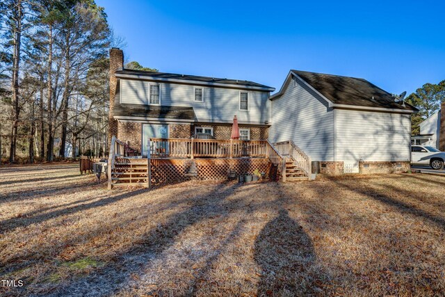 back of house with a deck