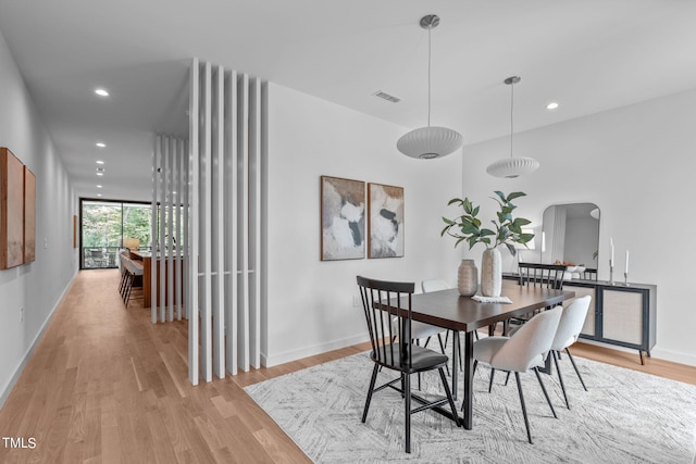 dining area with light hardwood / wood-style floors