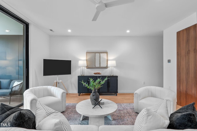 living room with ceiling fan and light hardwood / wood-style floors