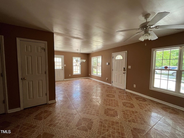 foyer entrance with tile patterned flooring and ceiling fan