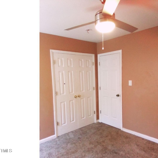 unfurnished bedroom with ceiling fan, a closet, and carpet