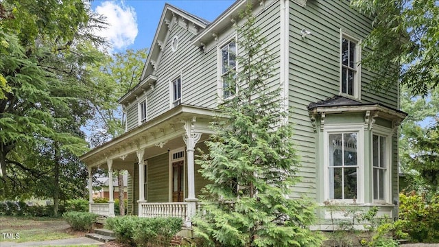 view of side of property with covered porch