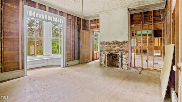 unfurnished living room with a brick fireplace