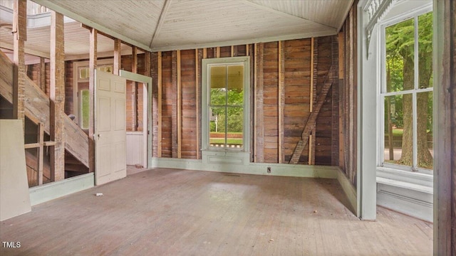 unfurnished sunroom with a healthy amount of sunlight and lofted ceiling