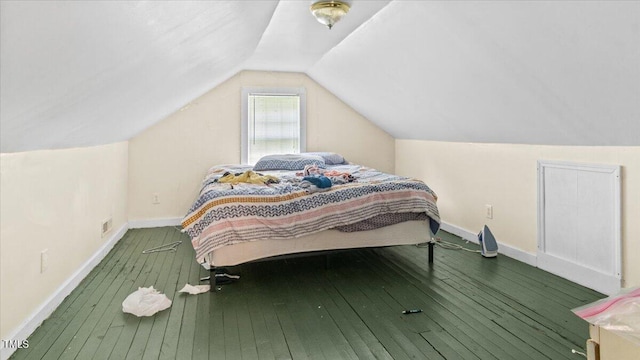 bedroom with lofted ceiling and hardwood / wood-style flooring