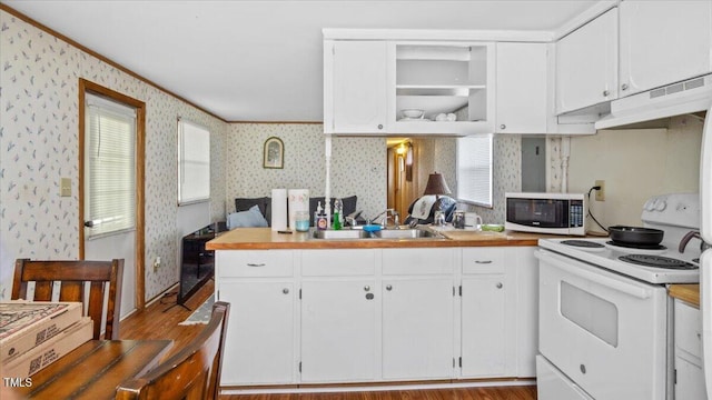 kitchen featuring white appliances, white cabinetry, and sink