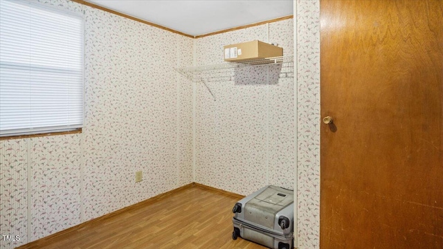 interior space with wood-type flooring and ornamental molding