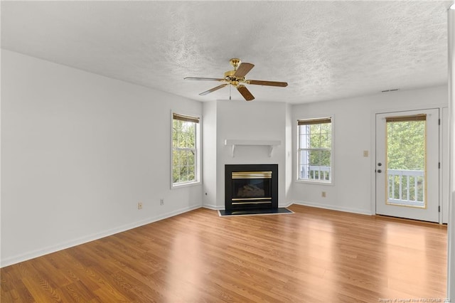 209 Waterdown Dr Unit 6, Fayetteville, NC 28314 - unfurnished living room with light wood finished floors, a fireplace with flush hearth, a textured ceiling, and a ceiling fan