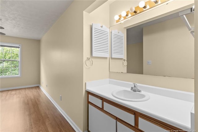 bathroom with vanity, wood-type flooring, and a textured ceiling