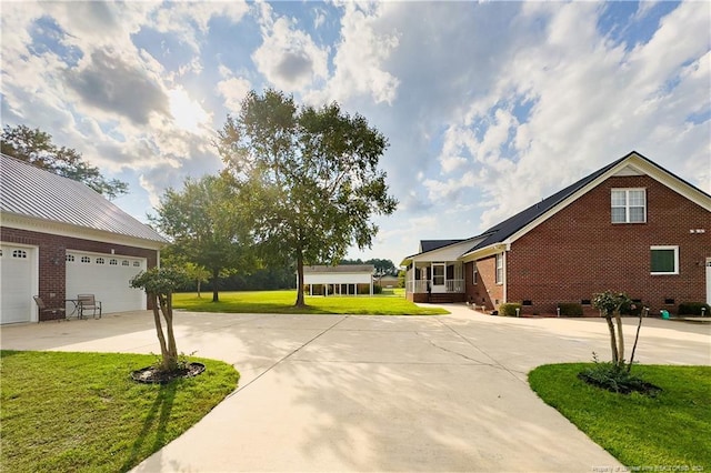 view of side of property with a garage and a lawn