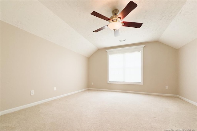 bonus room featuring ceiling fan, carpet floors, a textured ceiling, and vaulted ceiling