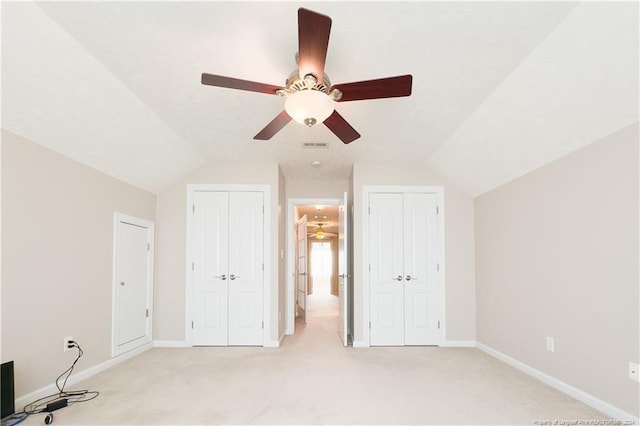 interior space with light colored carpet, vaulted ceiling, and ceiling fan