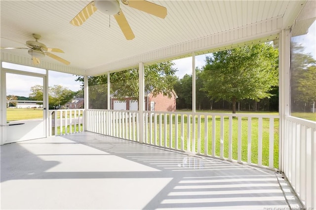 unfurnished sunroom featuring ceiling fan