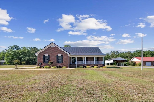 4419 Cameron Rd, Hope Mills, NC 28348 - view of front of property with covered porch, a front lawn, brick siding, and a metal roof