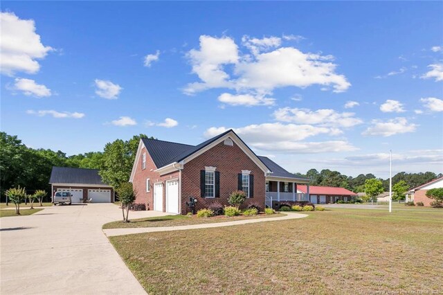 4419 Cameron Rd, Hope Mills, NC 28348 - view of front facade with brick siding, a front lawn, concrete driveway, an attached garage, and covered porch