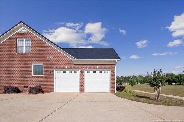 4419 Cameron Rd, Hope Mills, NC 28348 - view of home's exterior with concrete driveway, brick siding, an attached garage, a metal roof, and crawl space