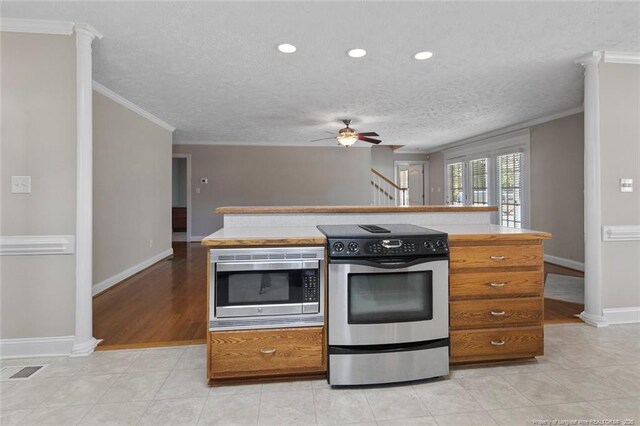 4419 Cameron Rd, Hope Mills, NC 28348 - kitchen with appliances with stainless steel finishes, crown molding, ceiling fan, a textured ceiling, and brown cabinets