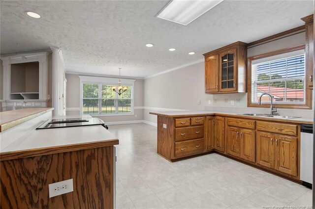 4419 Cameron Rd, Hope Mills, NC 28348 - kitchen with a peninsula, brown cabinets, ornamental molding, a textured ceiling, and a chandelier