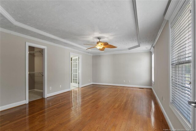 4419 Cameron Rd, Hope Mills, NC 28348 - unfurnished bedroom with a textured ceiling, hardwood / wood-style flooring, a spacious closet, attic access, and ornamental molding