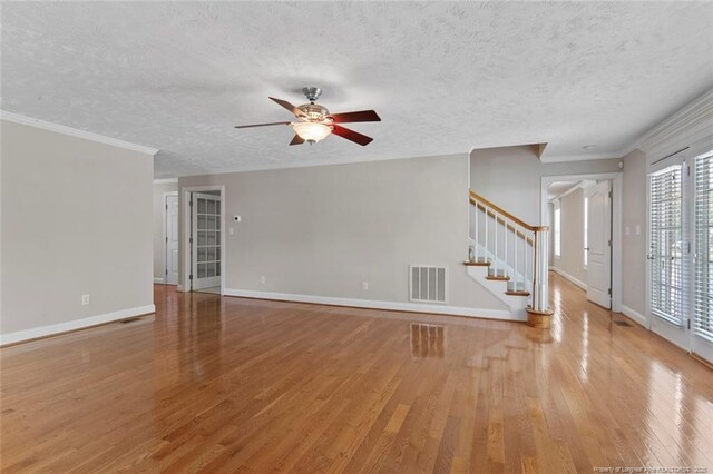 4419 Cameron Rd, Hope Mills, NC 28348 - unfurnished living room featuring wood finished floors, ceiling fan, stairway, a textured ceiling, and ornamental molding