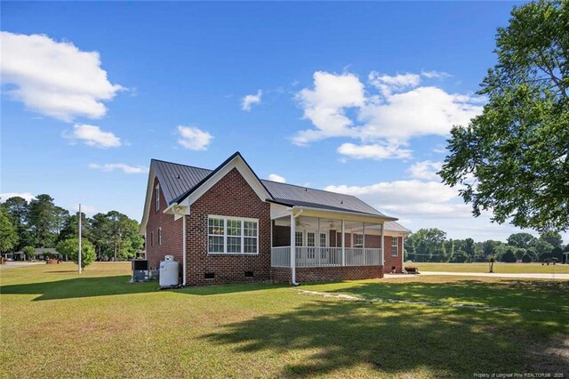 4419 Cameron Rd, Hope Mills, NC 28348 - back of house with crawl space, a yard, brick siding, and a metal roof