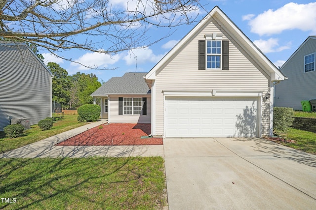 view of front facade with a garage and a front lawn