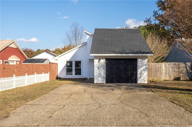 view of front of property with a garage and a front lawn