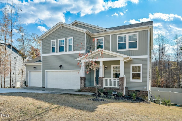 craftsman-style house featuring a front yard, a porch, and a garage