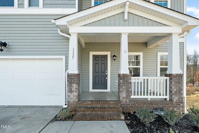 view of exterior entry featuring covered porch