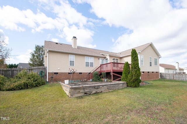 back of house with a deck and a lawn