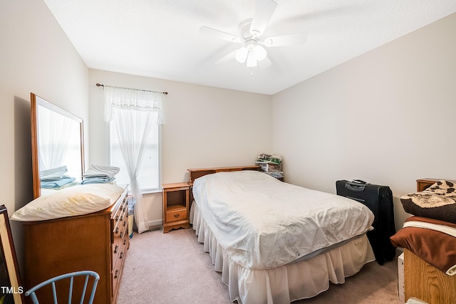 bedroom featuring ceiling fan and light carpet