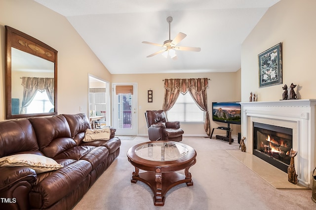 carpeted living room with ceiling fan, lofted ceiling, and a premium fireplace