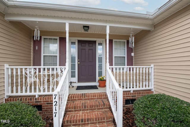 doorway to property featuring covered porch